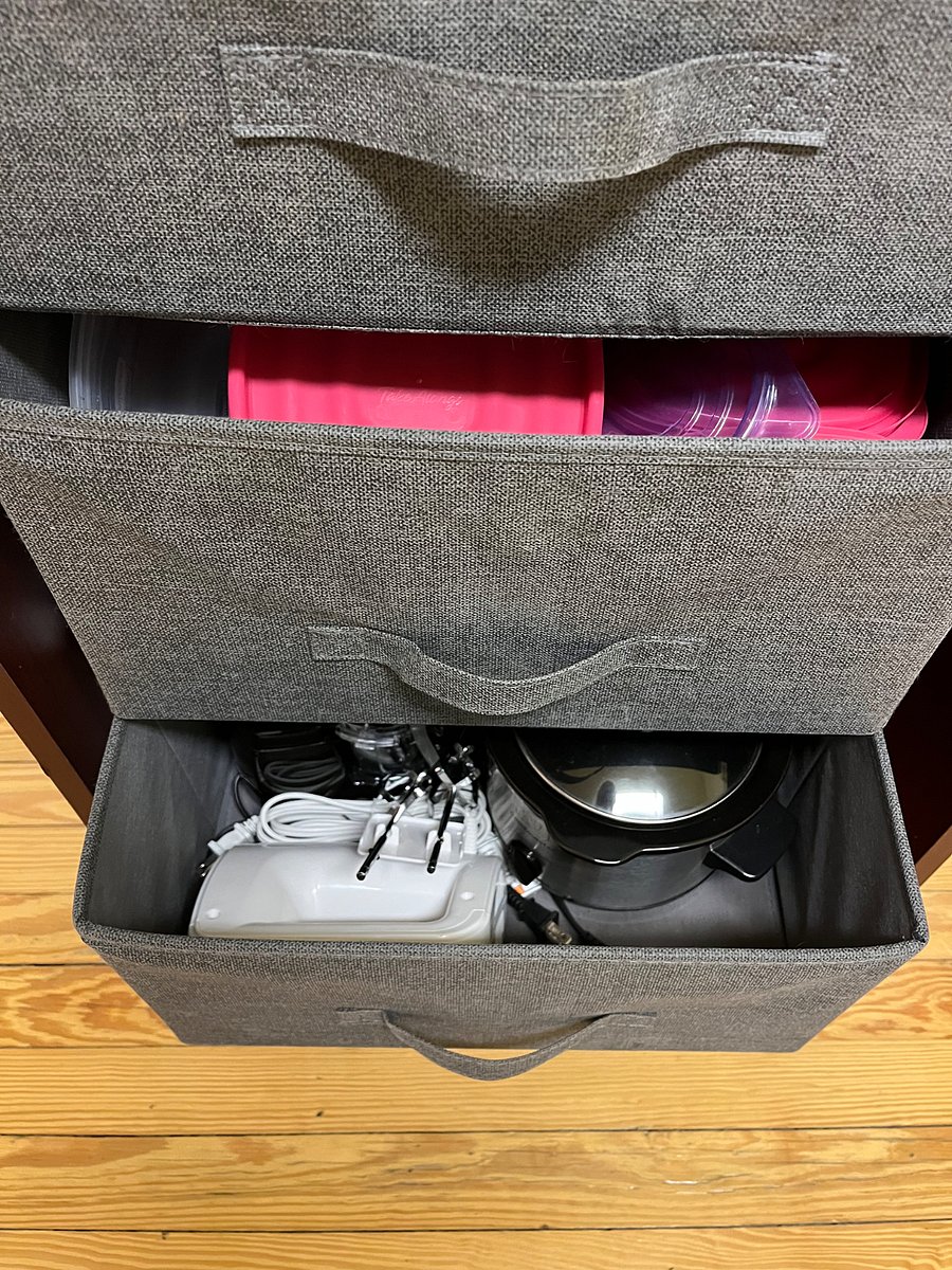 Tupperware containers, crockpot, mixer
Under the sink is a blender and reusable grocery bags to o take to the store because of NYSs no plastic bags law. 