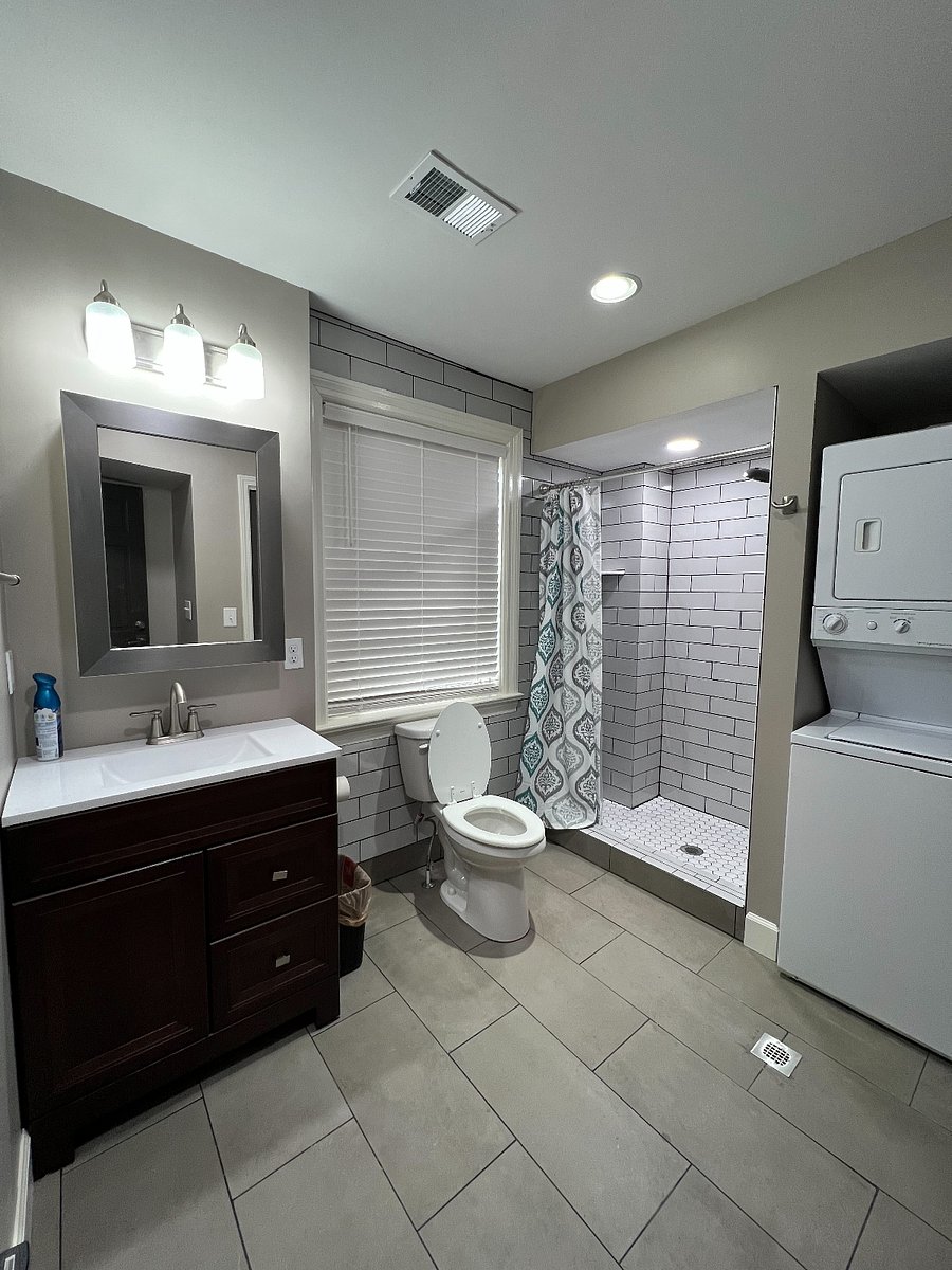 Front Bathroom w/ Shower & Stacked Washer/Dryer.