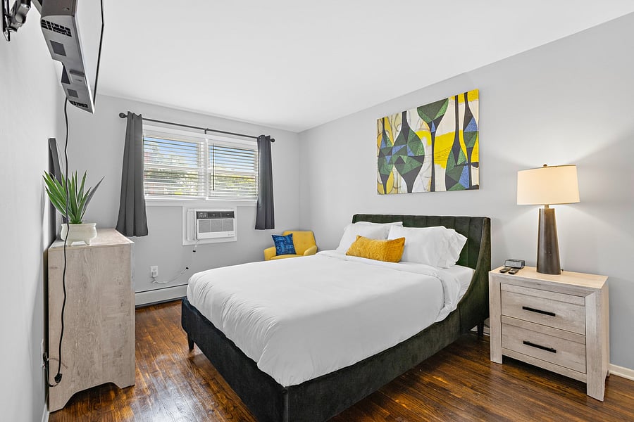 Queen bed in bedroom 1 with black out curtains