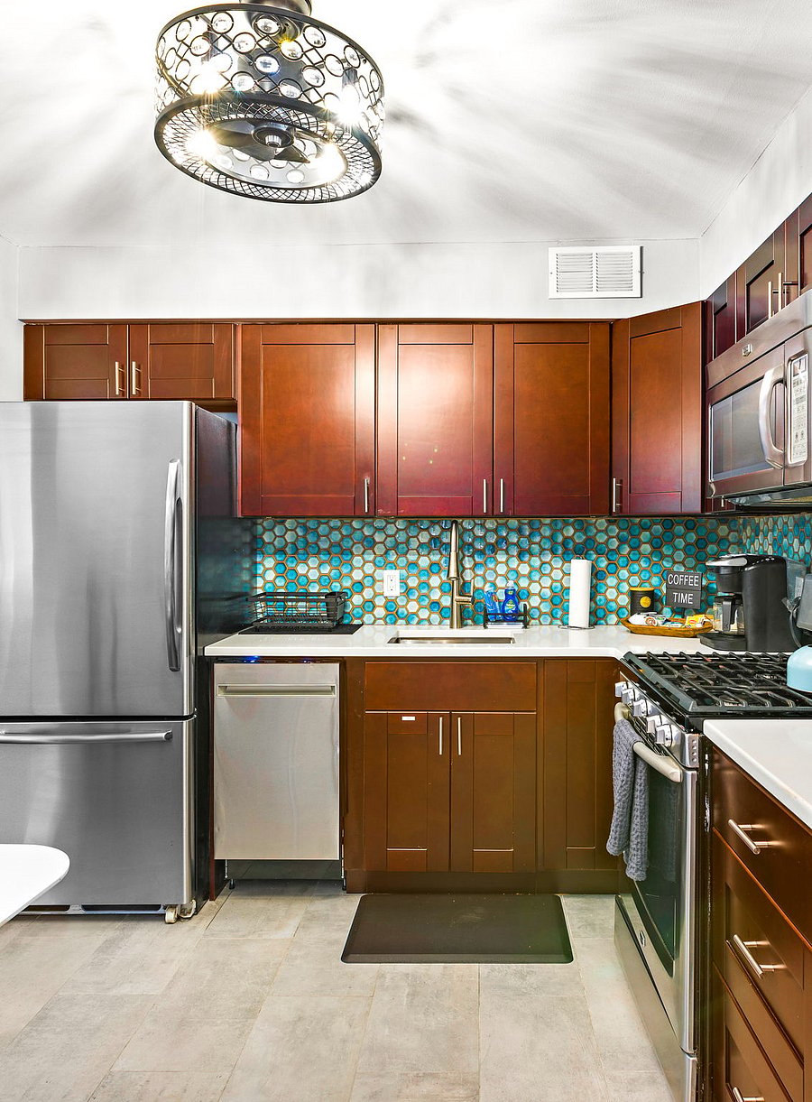 Full size kitchen with new cabinetry, white quartz countertops and stainless steel appliances