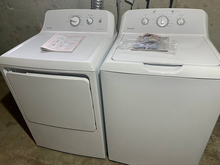Full sized washer dryer in the unfinished basement.