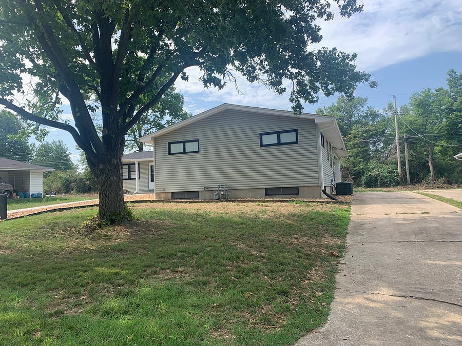 Shared drive behind duplex access each unit's carport space.