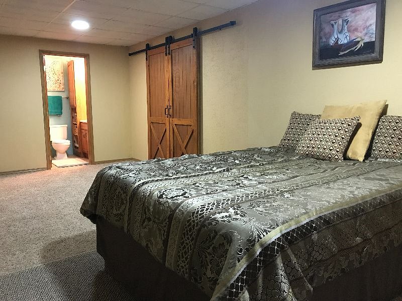 Open bedroom with attached full bathroom