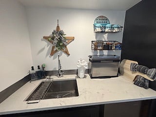 This quaint kitchenette is charming with every detail designed for function and flow. The compact countertop oven folds up when not in use, giving you more space to prep, plate, or simply enjoy a clean, open surface.