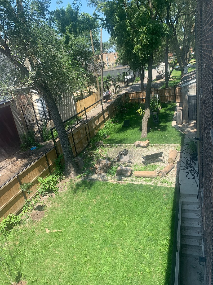 large side yard with fire pit, BBQ, picnic table and lights