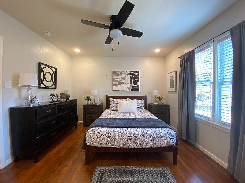 1st Bedroom with large window, dresser, 2 nightstands, queen bed with Purple mattress and hotel-quality linens