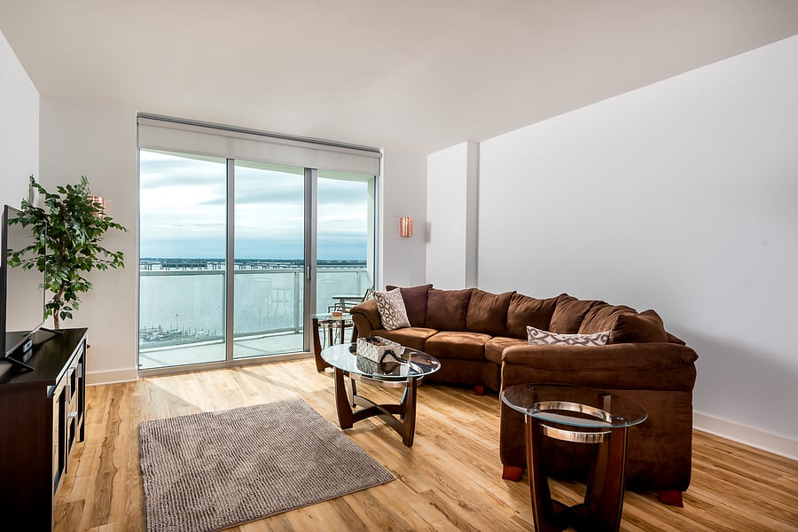 Living room with river views from high floor, couch replaced.
