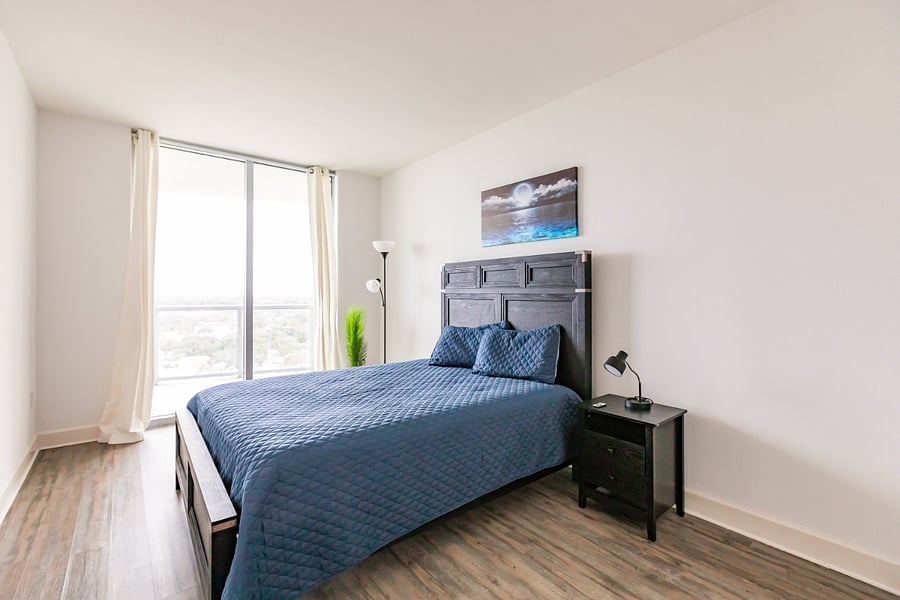 3rd bedroom with queen bed & city views