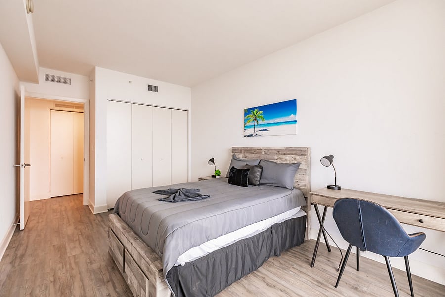 2nd bedroom full bed with workplace desk & city views
