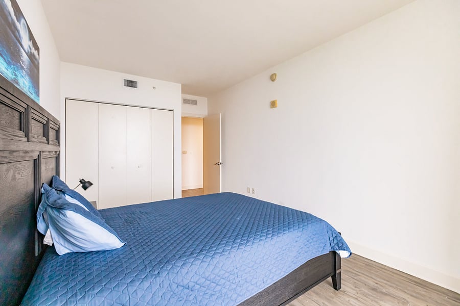 3rd bedroom with queen bed & city views