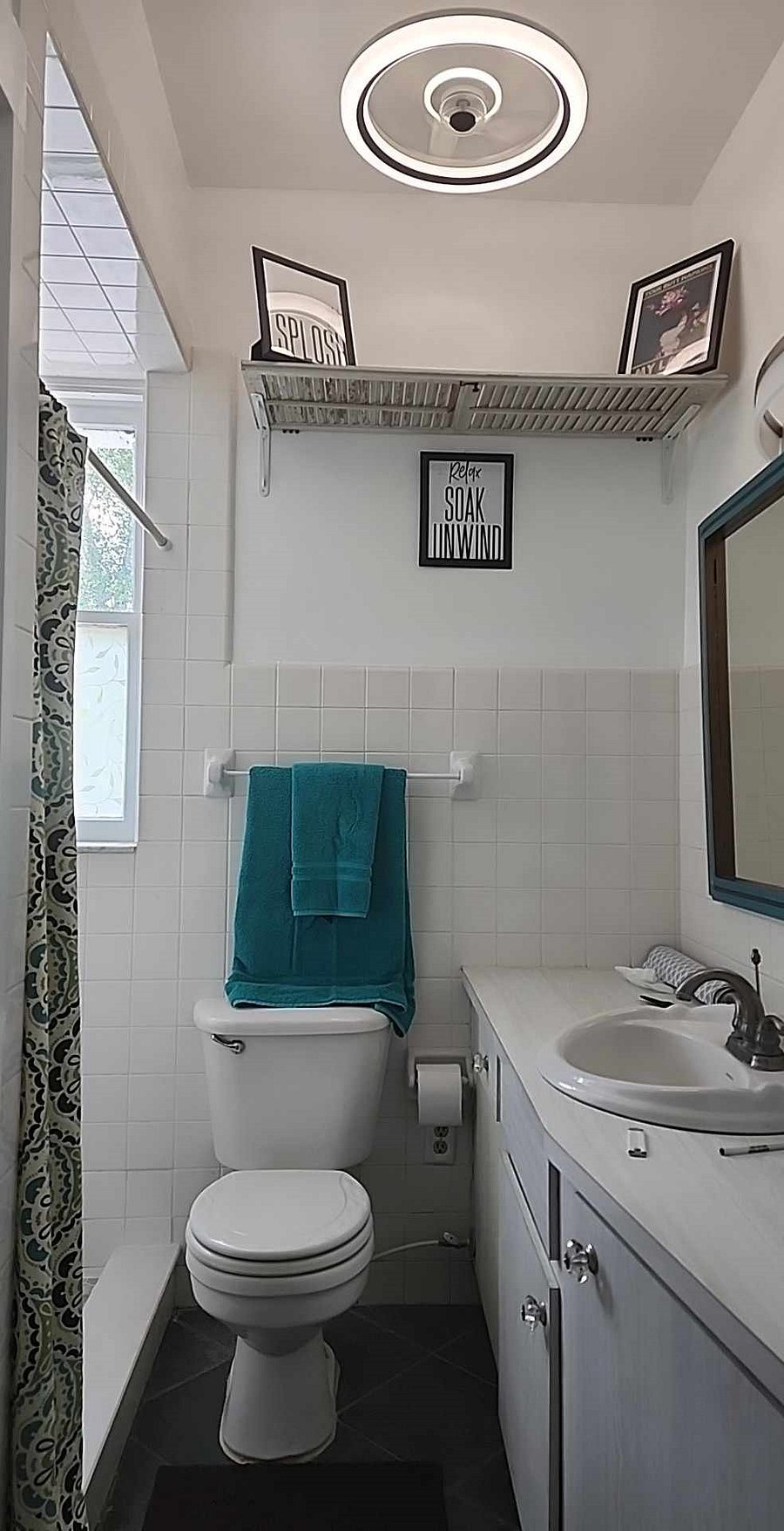 Walk in shower with plenty of storage space under the vanity and even a storage closet! New ceiling fan with lights you can see from the moon, too.