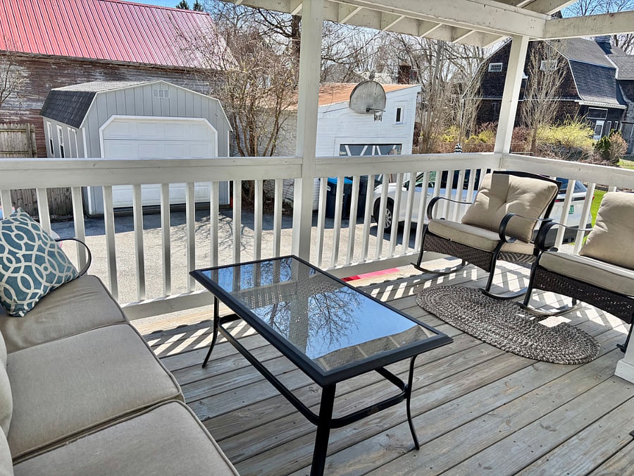 Private covered back porch with seating