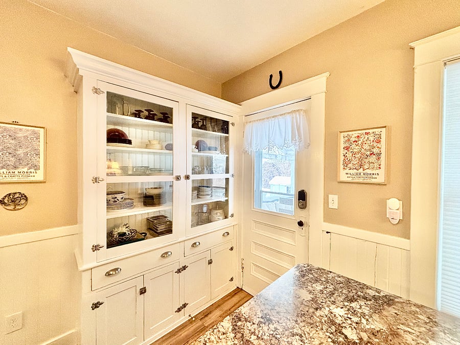 Kitchen stocked with dishware, china, glassware, crockpots, toaster oven, toaster, coffee pot, microwave, bakewear, pots and pans, mixer, and food processor