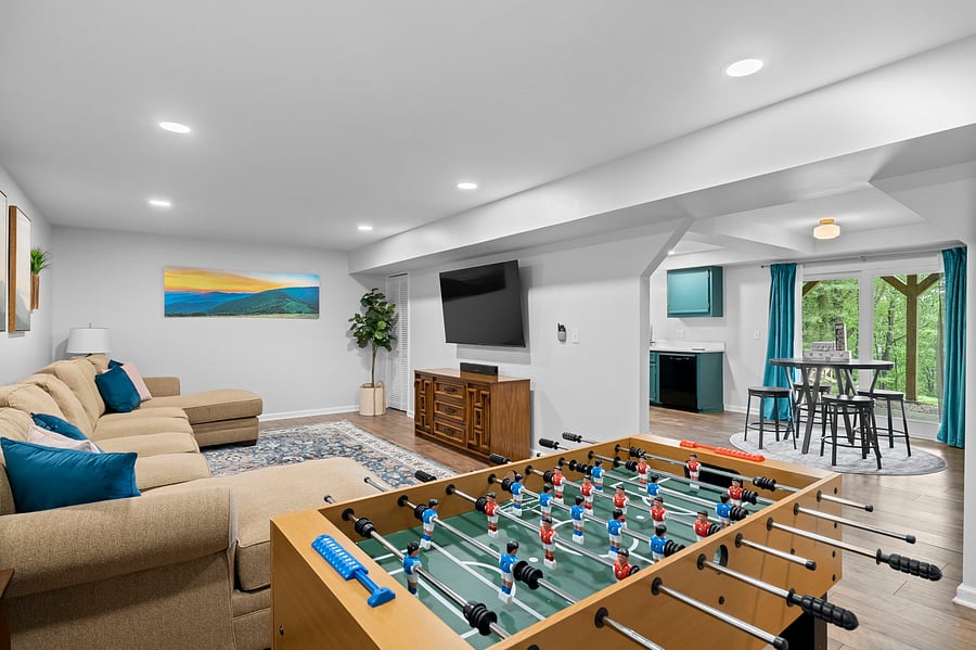 Downstairs large living room with 65" ROKU streaming TV, foosball and NBA Jams gaming console.