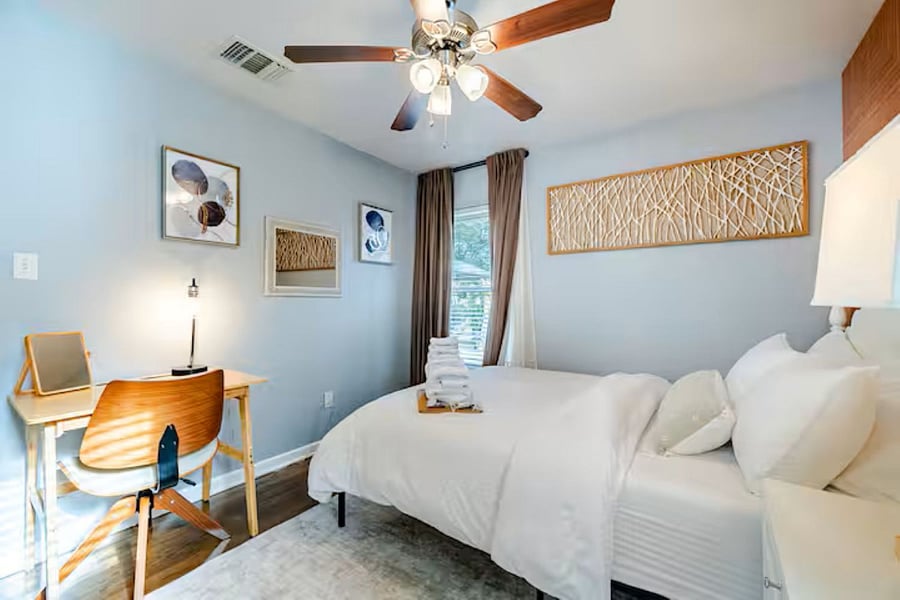 Bright and cozy third guest room equipped with blackout curtains and luxury linens to ensure a restful night's sleep for every guest."