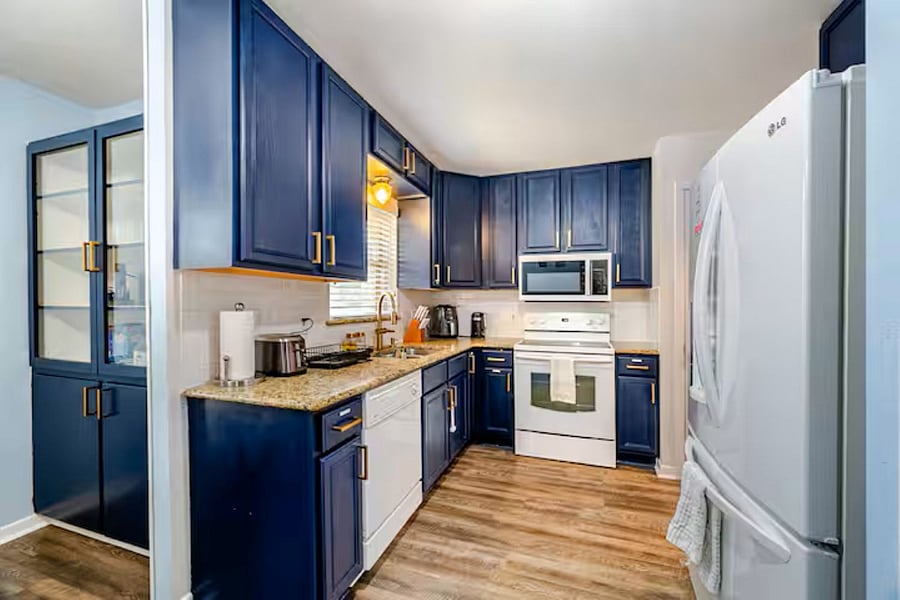Fully equipped kitchen featuring an air fryer, electric kettle, stove, oven, and microwaveeverything you need for effortless meal prep and home-cooked comfort.