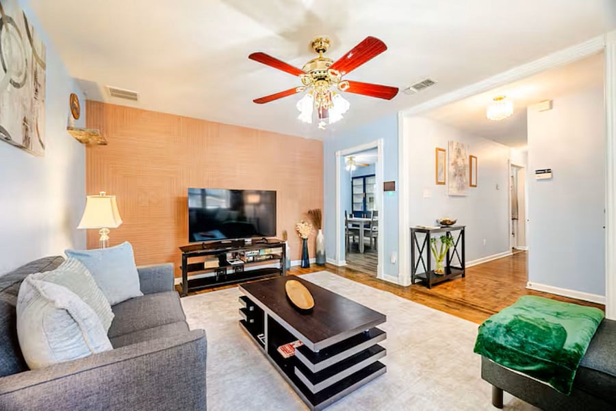 Bright and airy living space with plush seating and a smart TV. A cozy spot to relax and recharge."