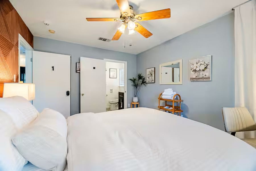 Primary Bedroom: "Serene primary suite featuring a premium queen mattress, blackout curtains, and luxury linens for a restorative sleep."