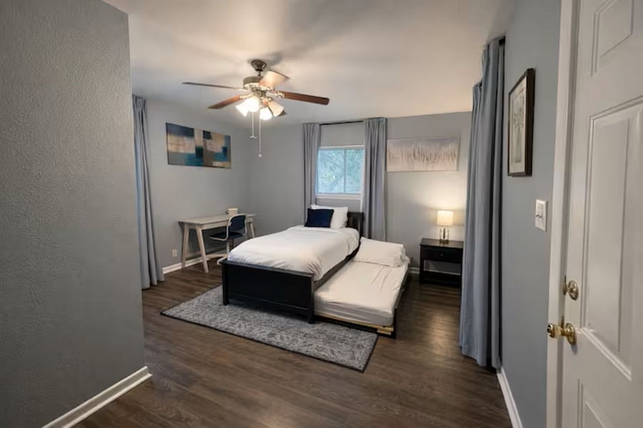 Versatile work-from-home space featuring a dedicated desk and a twin trundle bedperfect for a quiet office by day and a cozy guest room by night