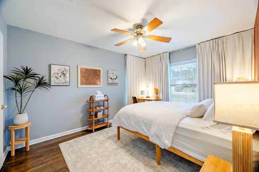 Primary Bedroom: "Serene primary suite featuring a premium queen mattress, blackout curtains, and luxury linens for a restorative sleep."