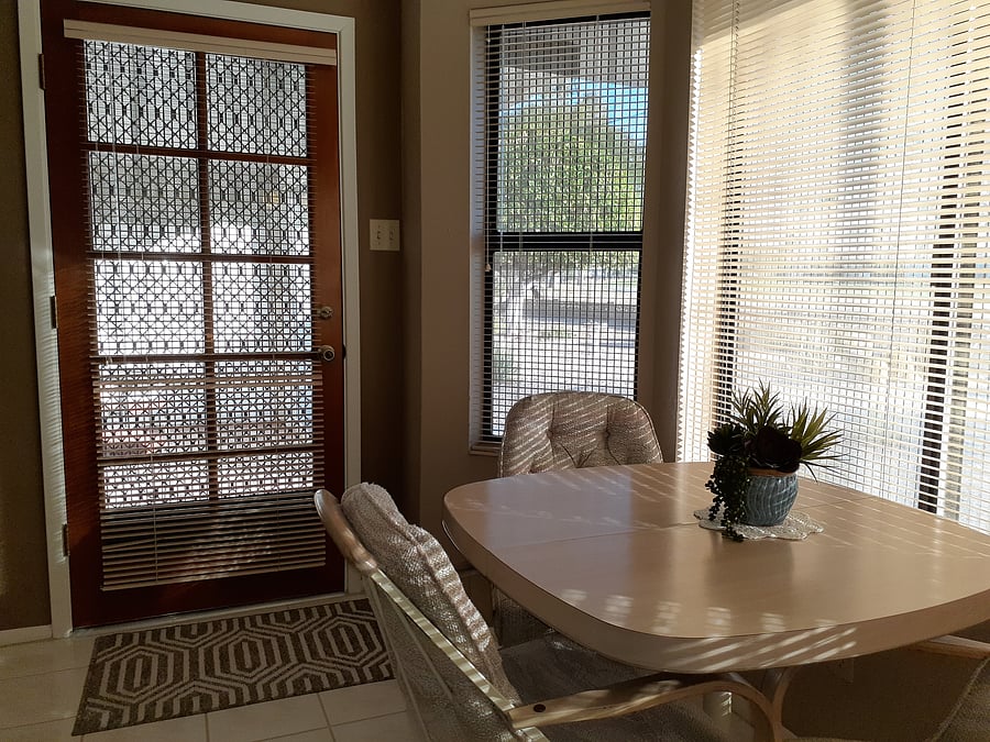 Entry from patio-porch into the eating area with table and 2 chairs. Windows are all around to see the golf-course beyond the desert garden back yard.
