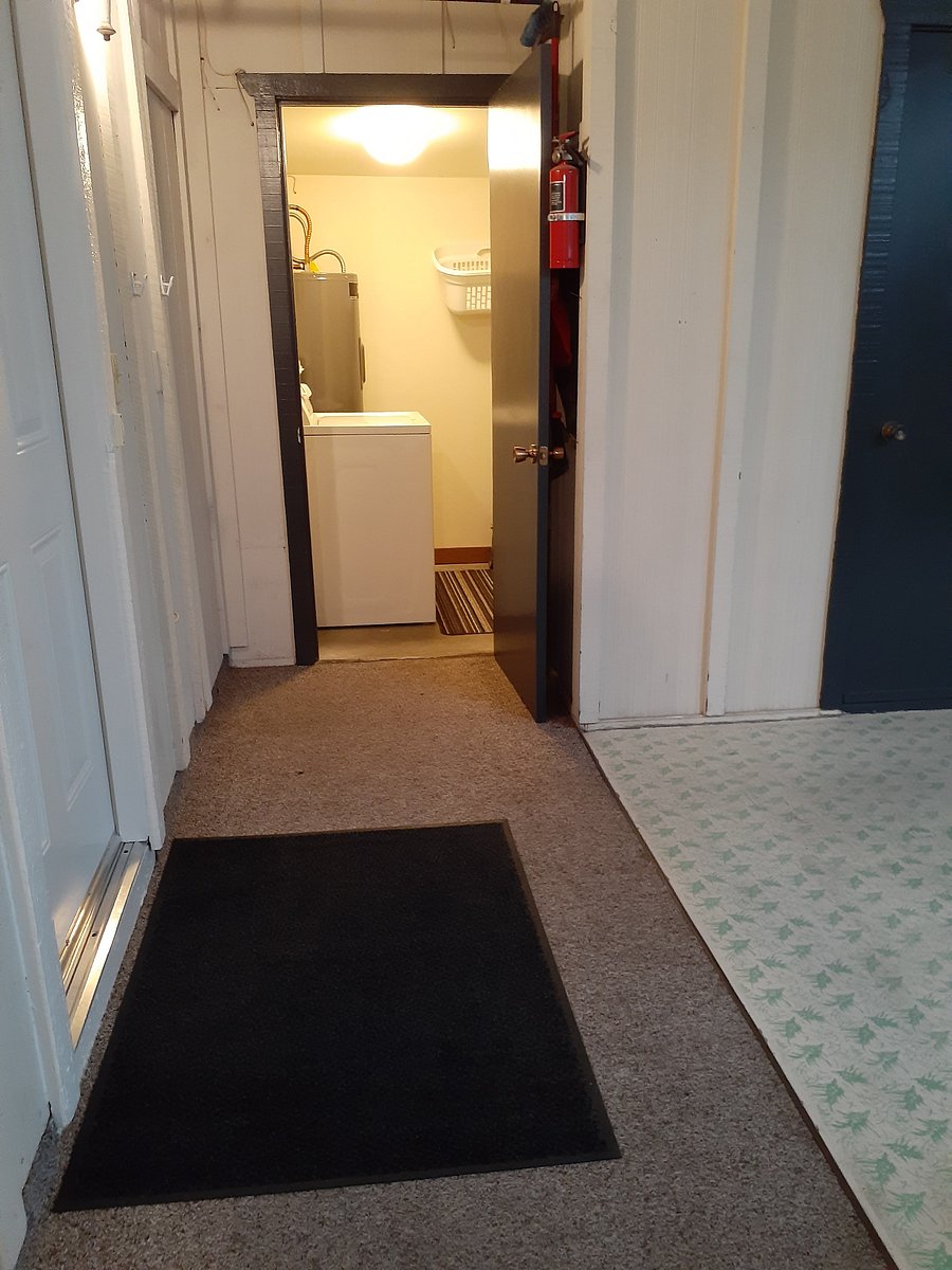 Apartment's storage room with a washing machine.