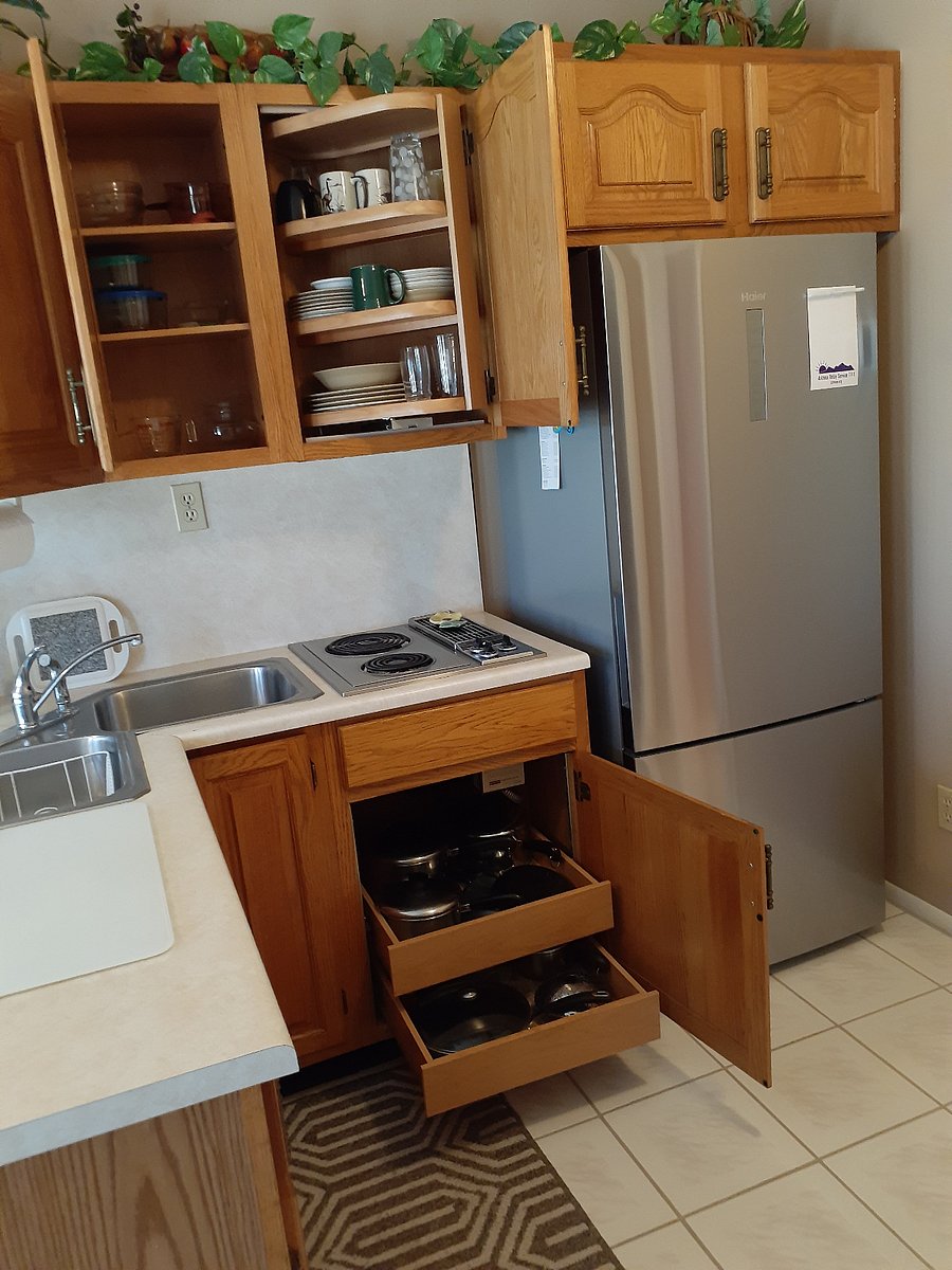 Handy pull-out shelving with more than enough space, dishware and cookware.