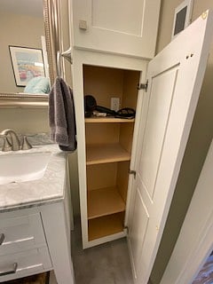 Hair dryer provided with electrical outlet in shelf