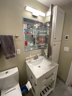 Mirror opens to spacious medicine cabinet