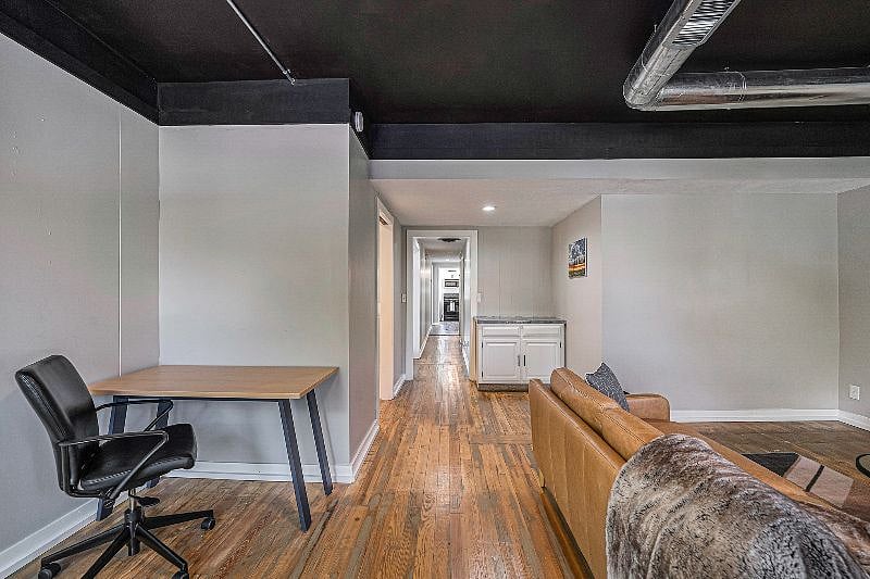 Desk area in living room with a swivel chair.