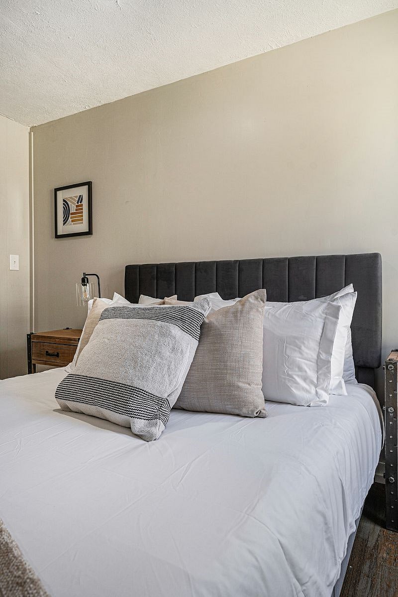 Primary bedroom has multiple sleeping pillows as well as decorative pillows. There are both soft and firm pillows to satisfy everyone's sleeping needs.