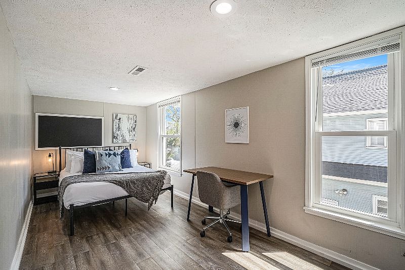 Second bedroom also has a queen bed. This bedroom also has a desk workspace with a swivel office chair.