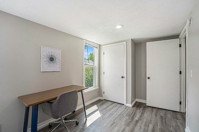 Workspace, closet, and entry door to second bedroom