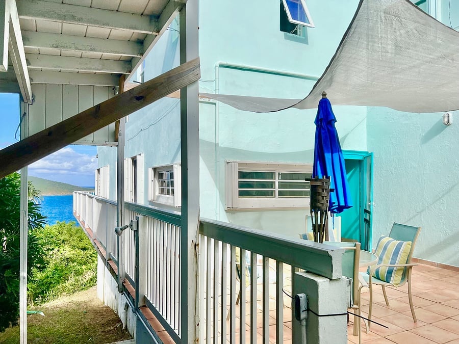 Stairway of deck leads to washer / dryer and a garden full of fruit trees and orchids!
