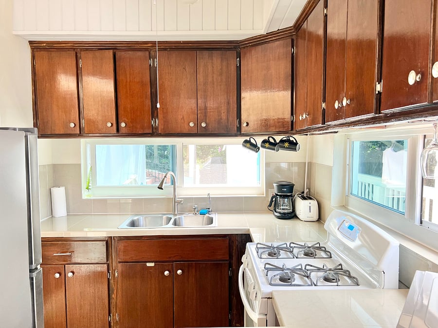 Beautiful mahogany cabinetry kitchen is filled with all your baking, serving needs...includes toaster, microwave, drip coffee maker, full size fridge, and full size gas oven. Includes extra water filtration at double sink.