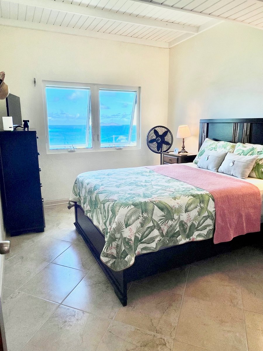 This bedroom also has spectacular views. 2 nightstands, 2 lamps and a queen bed. The extra high ceilings with ceiling fans and stand up fans make it easy not to use the AC as we have constant nice breezes here on Peterborg!