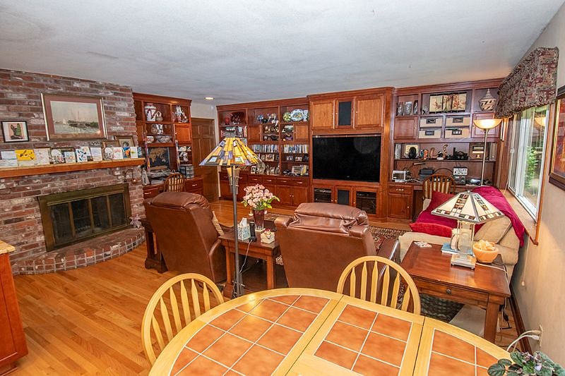 Dinette with family room and fireplace in background