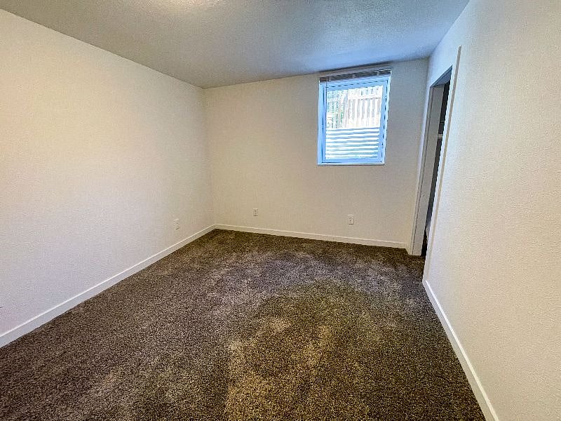 Larger unfinished basement bedroom. 