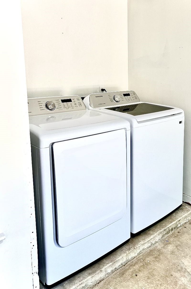 Full size washer and dryer and a starter supply of detergent, dryer sheets and cleaning supplies.