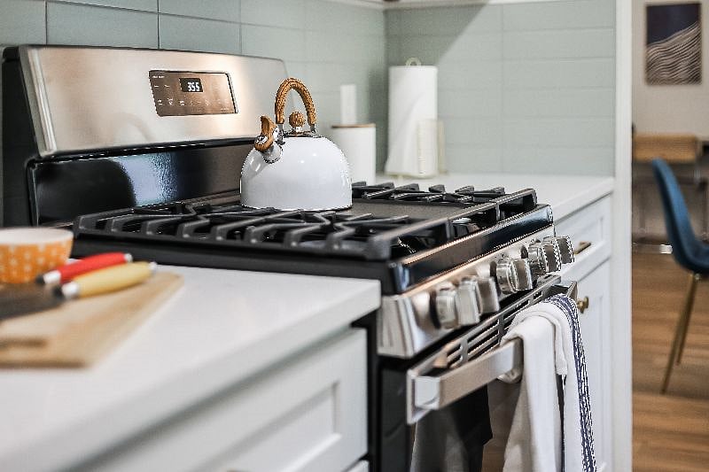 Kitchen - GE stainless steel 5 burner gas stove and oven with all the cooking amenities needed to cook delicious meals.
