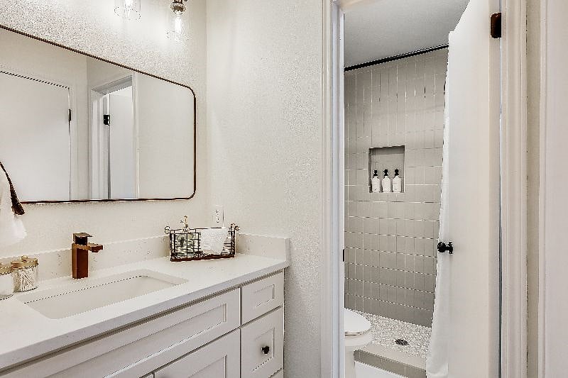 Primary en-suite walk-in shower complete with shampoo, conditioner, body wash, and hair dryer provided for your convenience. We have provided plenty of towels for your needs, including black make up towels.