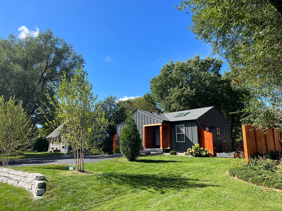 Fenced area to the left has private deck with 4 poly Adirondack chairs. 