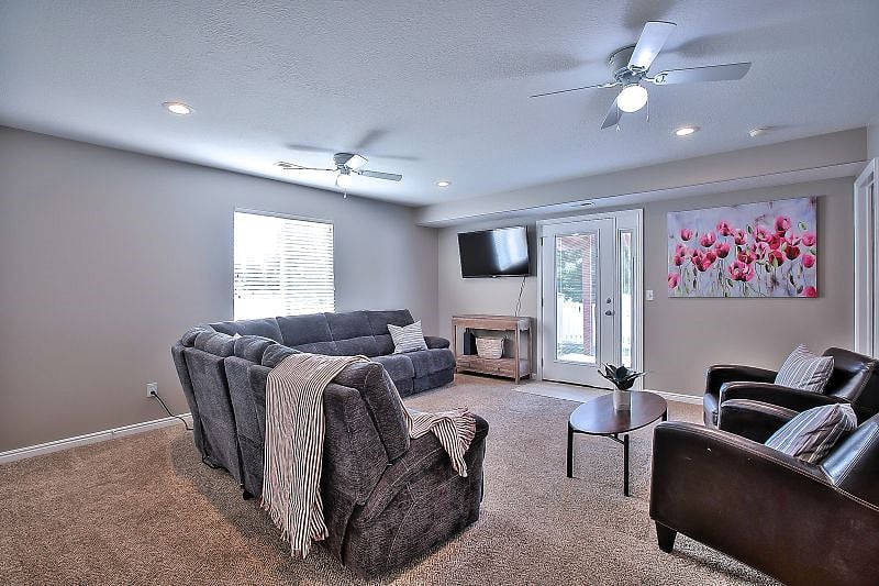 Large family room with reclining sectional and sofa bed, smart TV