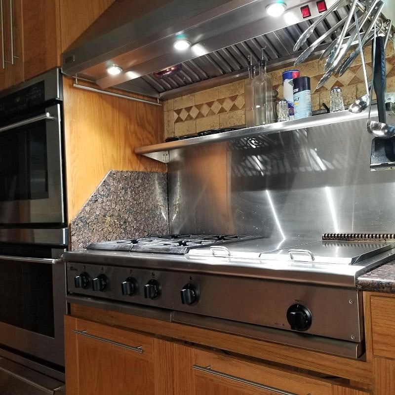 Shared range with burners, grill, and griddle