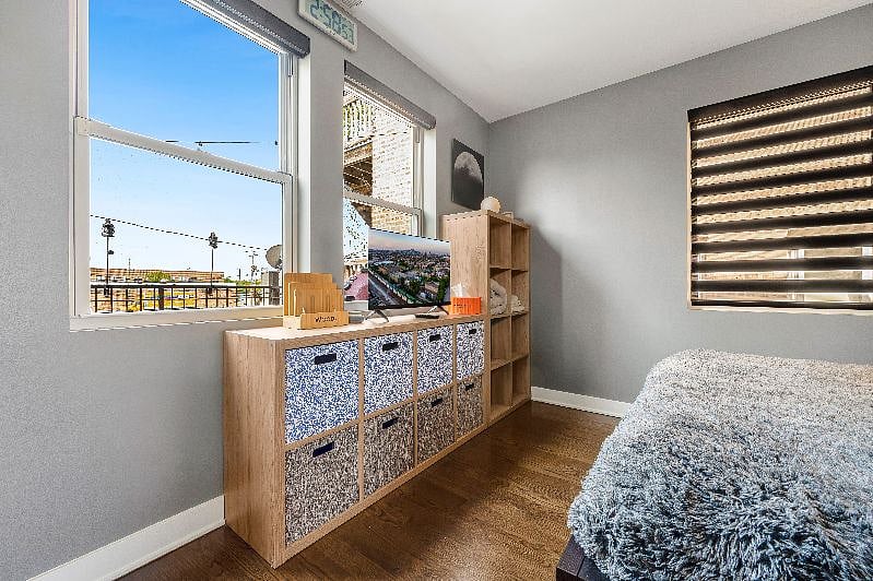 Plenty of natural light & storage! The bedroom looks out over your private second story patio, complete with tiki torches & colorful seating. No neighbors in back - a very private vibe.
