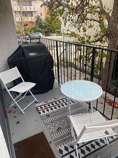 Outside patio including bistro table, chairs and grill