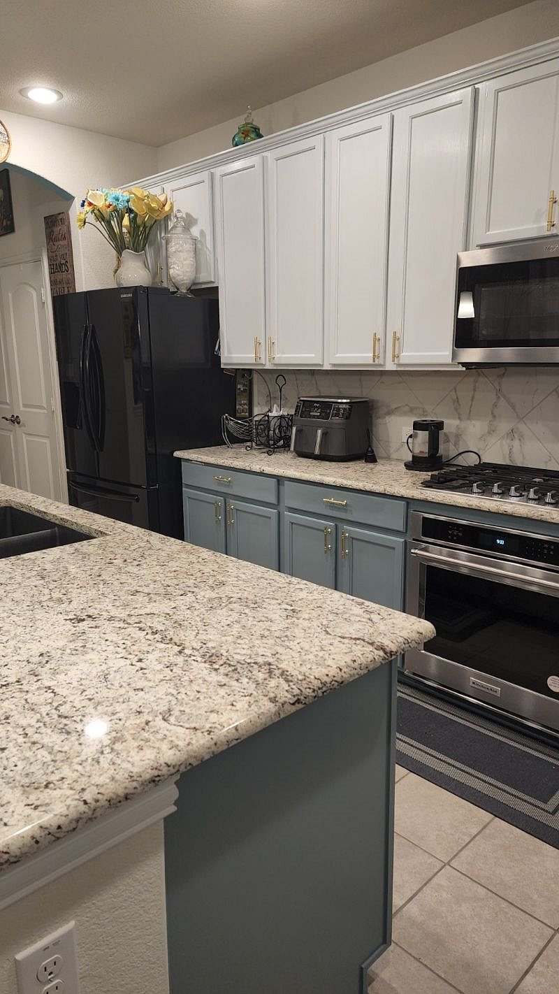 Kitchen with tea kettle, microwave, gas stove, refrigerator and airfryer all available for guest use.