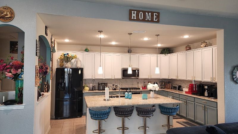 Kitchen on first floor with barstools and large kitchen island.