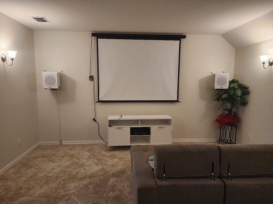 Media room cabinet with amp, projector screen and subwoofers.