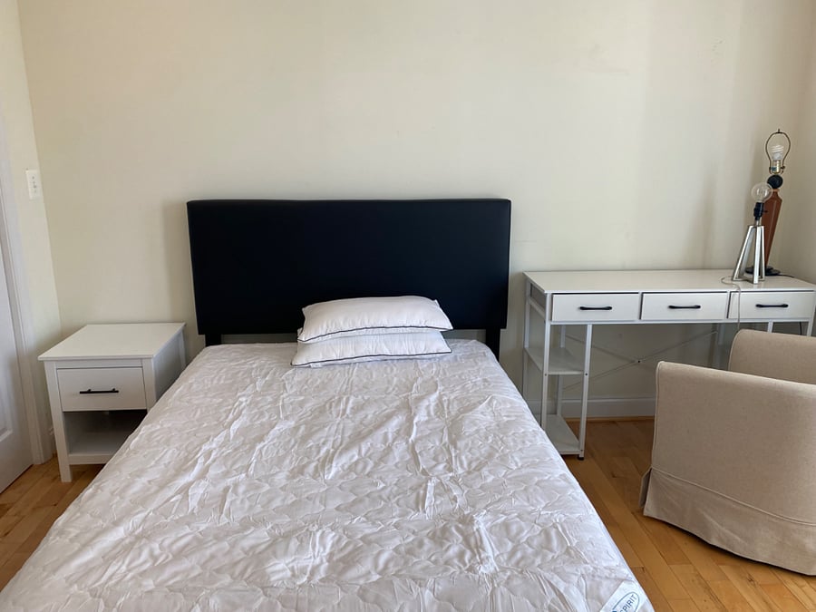 3rd bedroom with full-size bed, night stand, desk and seating.